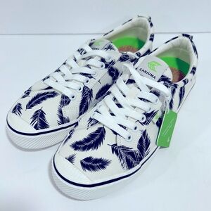 Cariuma OCA low canvas sneaker in off white with black palm leaves.